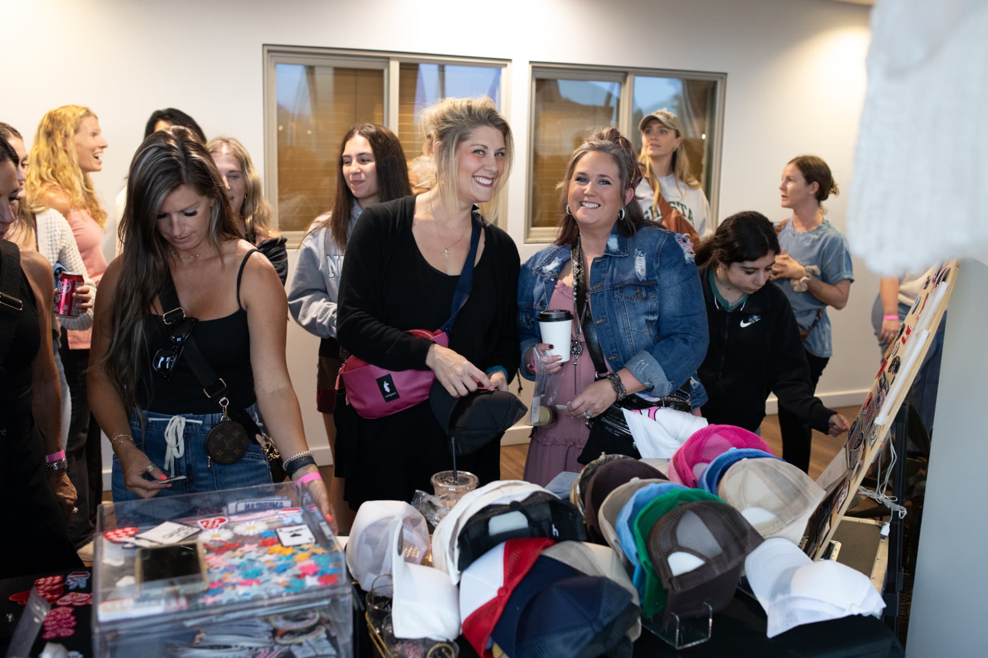 Women browsing BLUSH vendor hats, jewelry, and accessories